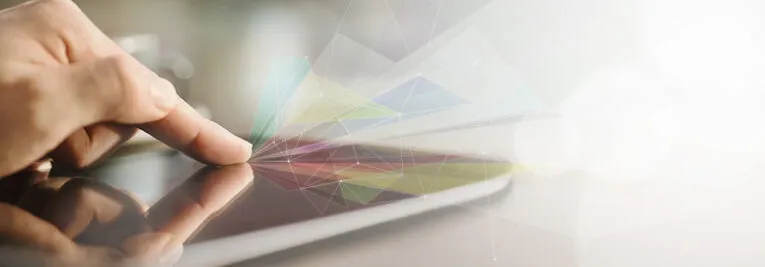 A finger touches the screen of a tablet, with abstract colorful digital patterns emerging from the point of contact, resembling techniques from three Photoshop tricks to enhance and extend your images.