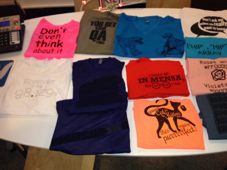 A table displays ten colorful graphic t-shirts with various humorous and text-based designs and messages created by The PaperStreet Team.