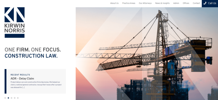 Construction site with a crane and building framework. Text reads "Kirwin Norris: One Firm. One Focus. Construction Law." with links to About Us, Practice Areas, Our Attorneys, News & Insights, Admin, Contact, and a call button. 2024 Update: The Different Types of Home Page Content now available!