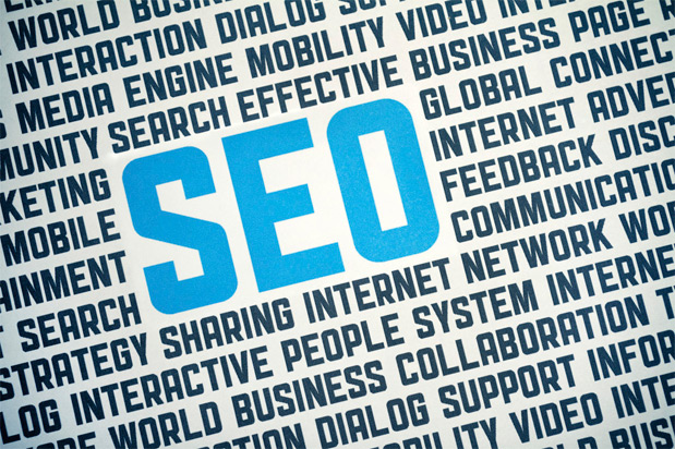 The image features the word "SEO" prominently in blue, centered among various related terms such as "Internet," "Search," "Networking," and "Business" in a typographic layout, reflecting new optimization standards for web content.