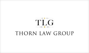 Logo of Thorn Law Group featuring "TLG" in bold letters above "Thorn Law Group," with small decorative elements on a white background. This best law firm logo design captures sophistication and professionalism effortlessly.