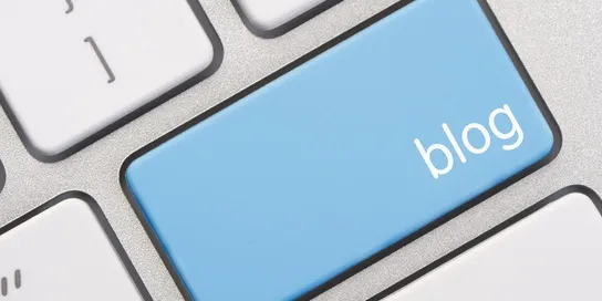 Close-up of a computer keyboard with a blue key labeled "5 Ways Guest Blogging Can Help Your Law Firm" replacing one of the standard keys.