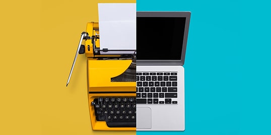 Half typewriter and half laptop on a split yellow and blue background, symbolizing the transition from old to new technology—much like choosing between using Google Docs vs. Microsoft Word for modern document creation.