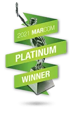 MarCom 2021 Platinum Winner trophy with a green zigzagging ribbon and a silver statuette holding an award.
