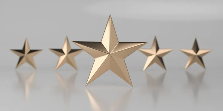 A row of five golden stars aligned on a reflective surface, with the center star larger and more prominent than the others.