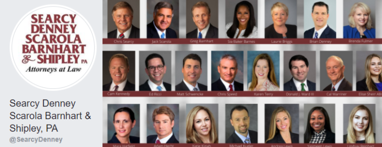 A composite image shows the headshots of legal professionals from Searcy Denney Scarola Barnhart & Shipley, PA, with their names listed underneath their photos. The firm’s logo appears on the left side.