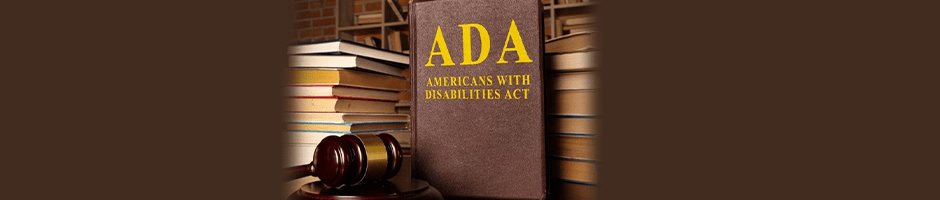 A book titled "ADA Americans with Disabilities Act" is displayed upright on a table with a gavel in front and a stack of books in the background.