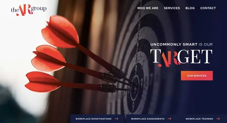 Three red darts hit the center of a black and white dartboard. Text on the right reads "Uncommonly Smart is Our Target" beside a red button labeled "Our Services." The top menu includes services and contact.