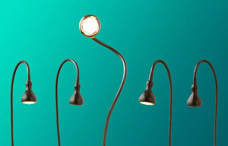 Five gooseneck lamps, with the middle one lit and standing taller than the others.