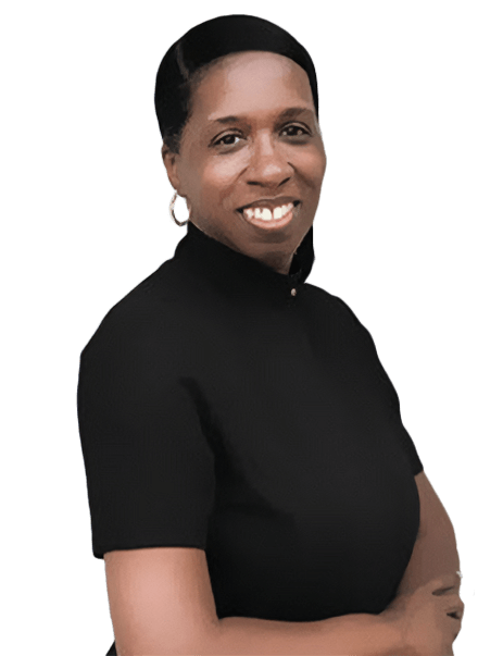 A person with short hair and hoop earrings, wearing a black shirt, is standing with arms crossed and smiling. The background is white.