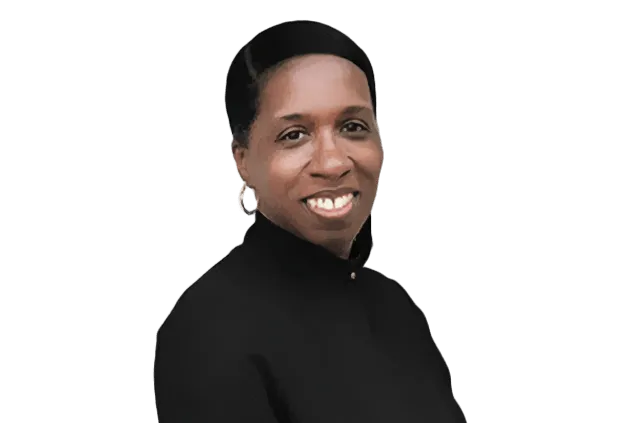 A person with short hair and earrings is smiling, wearing a high-neck black top, against a white background.