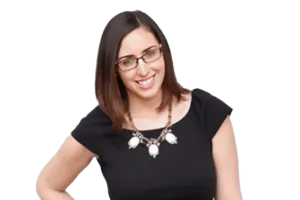 Woman wearing glasses and a black shirt, smiling at the camera.