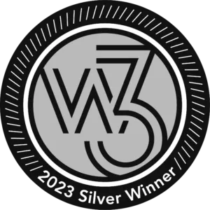 A circular logo with "2023 Silver Winner" text around the border and a central design featuring stylized letters "W3.