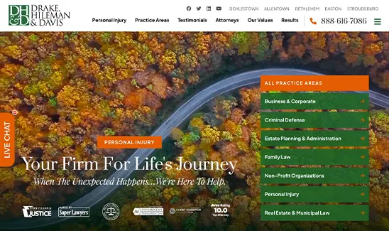 Aerial view of a winding road through a forest in autumn displayed on a law firm's website. The text highlights practice areas like personal injury, business & corporate, and criminal defense.