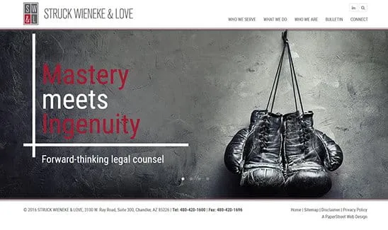 Website screenshot of Struck Wieneke & Love law firm featuring a pair of boxing gloves and text that reads, "Mastery meets Ingenuity. Forward-thinking legal counsel." Contact information is provided at the bottom.