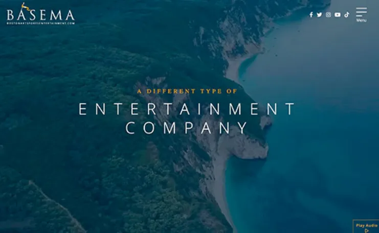 Aerial view of a coastal landscape with text "A Different Type of Entertainment Company" and the company name "Basema" displayed. Social media icons are in the upper right corner.