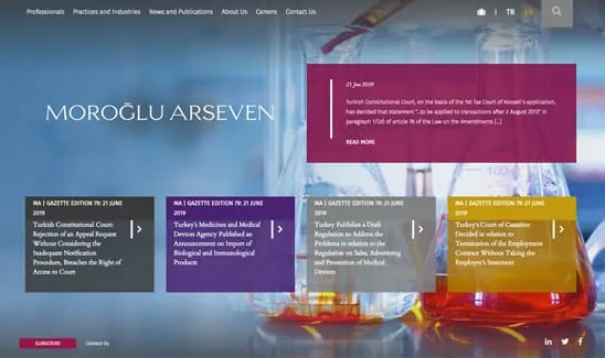 A website homepage for Moroğlu Arseven, featuring updates on various legal matters and publications, displayed on a background of laboratory equipment.