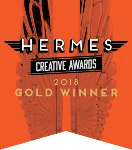 Hermes Creative Awards 2018 Gold Winner with a stylized graphic of wings and bold text on an orange background.