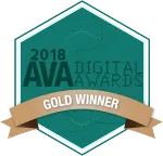 2018 AVA Digital Awards Gold Winner badge featuring a hexagonal green background with a brown ribbon displaying the text "Gold Winner".