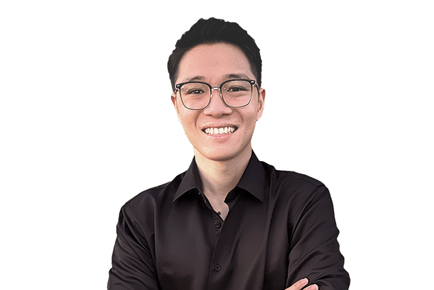 A person wearing glasses and a black shirt smiles with crossed arms in front of a plain, white background.