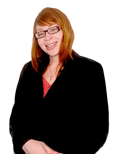 A person with long brown hair and glasses, wearing a dark blazer over a red top, smiles at the camera.