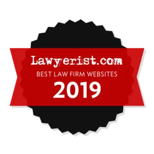 Red ribbon badge with the text "Lawyerist.com Best Law Firm Websites 2019" on a circular black and white background.