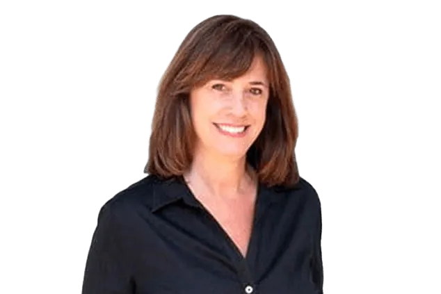 A woman with shoulder-length brown hair is smiling at the camera. She is wearing a black, button-up shirt. The background is white.