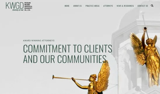Website homepage of Krugliak, Wilkins, Griffiths & Dougherty Co., L.P.A., showcasing a slogan "Commitment to Clients and Our Communities" against a backdrop of golden statues blowing trumpets.
