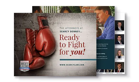 A promotional flyer for Searcy Denney featuring red boxing gloves with the text "Ready to Fight for you!" and images of attorneys on the back.