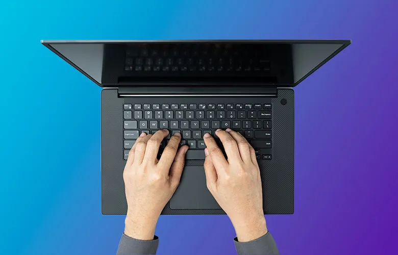 Top view of a person typing on a black laptop with a gradient blue and purple background, adhering to ADA best practices for keyboard accessibility.