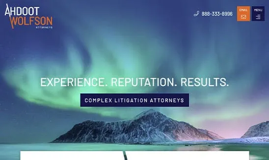 Image of a homepage for Ahdoot Wolfson Attorneys with a background of the Northern Lights over a mountain range. The text reads: "Experience. Reputation. Results. Complex Litigation Attorneys.