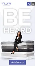 Advertisement for YLaw featuring a person seated on a stack of mattresses with the words "BE HEARD" prominently displayed. A button at the bottom reads "Get in Touch.