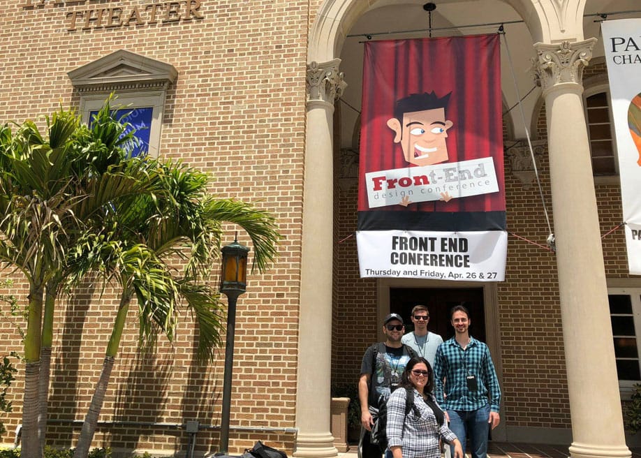 A group of people standing outside a theater with a banner that reads "Front End Design Conference" scheduled for Thursday and Friday, April 26 & 27.