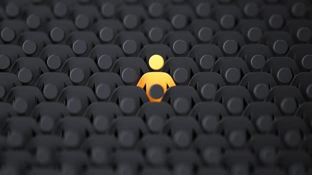 A grid of black human-shaped figures with one yellow figure in the center, emphasizing individuality.