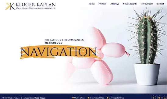 Website homepage of Kluger Kaplan law firm featuring a balloon animal dog and a cactus plant with the text "Precarious Circumstances, Meticulous Navigation." Offices listed at the bottom.