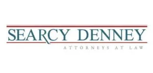 Logo of Searcy Denney Attorneys at Law, featuring the firm's name in blue uppercase text with red horizontal lines above and below.