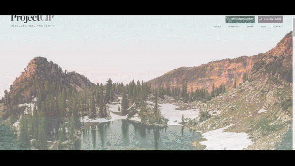 A website homepage featuring a serene mountain landscape with a lake, scattered trees, and rocky terrain. Contact information and navigation links are displayed at the top.