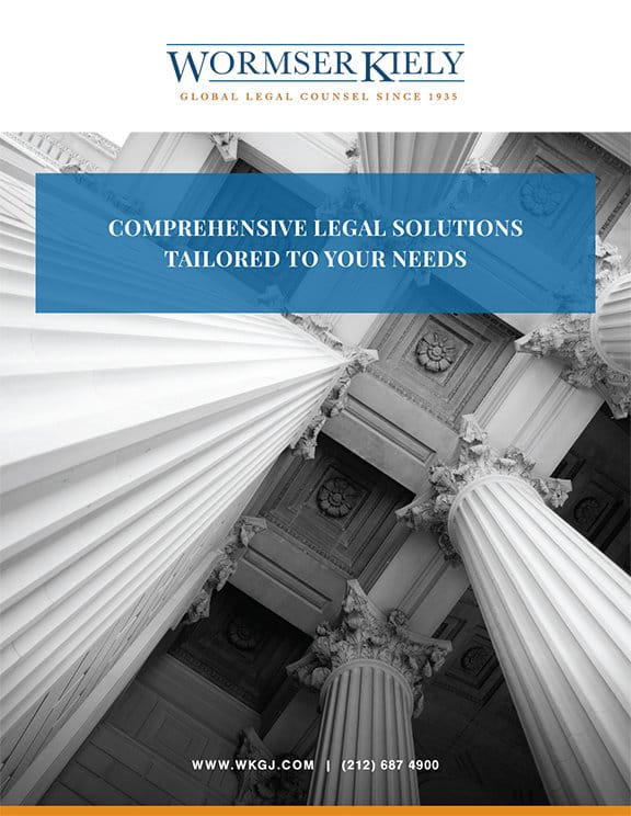 Advertisement for Wormser Kiely law firm, featuring a view of classical columns and offering comprehensive legal solutions. Contact details and website are included below the image.