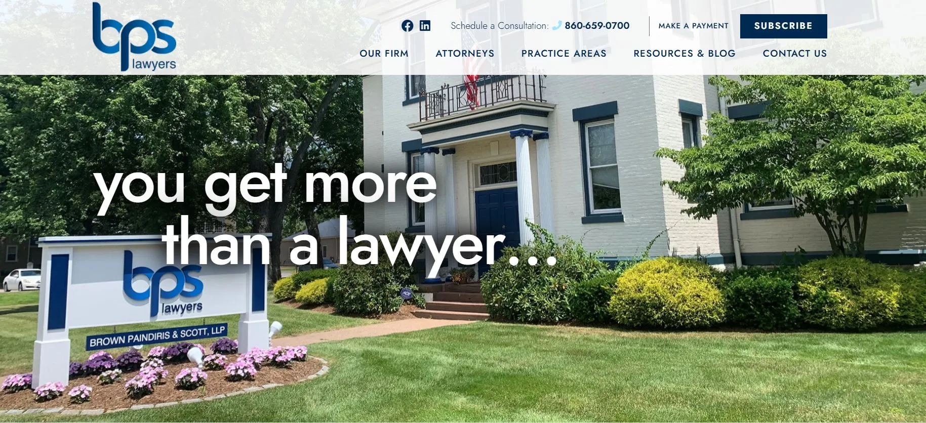 Front view of a law office building with "bps lawyers" sign and manicured landscaping.