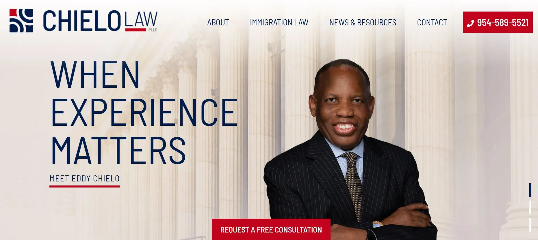 A man in a suit stands smiling in front of tall columns with the text "When Experience Matters.