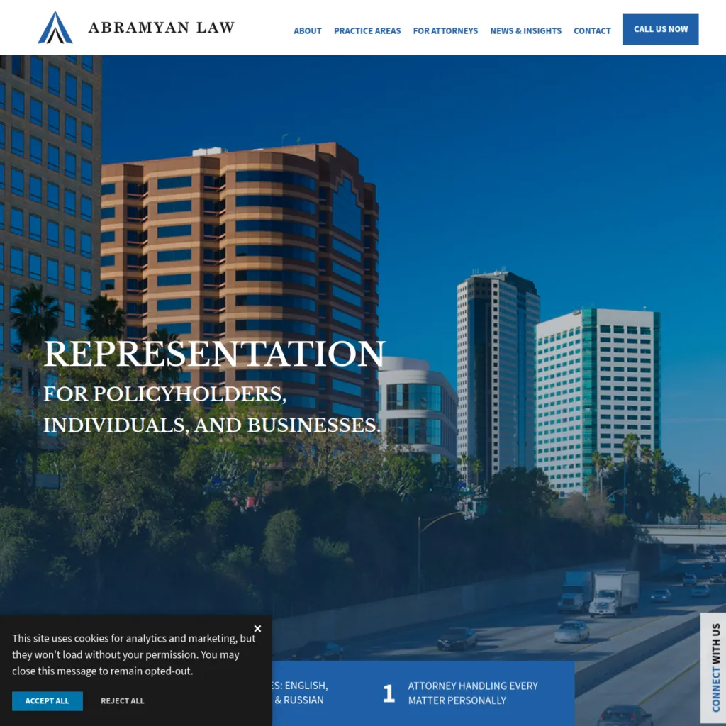 Downtown city buildings with a freeway in front; Abramyan Law website header and navigation visible.