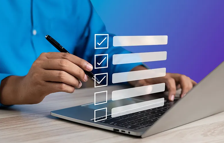 Person using a laptop with a checklist graphic overlay, marking items with a pen.