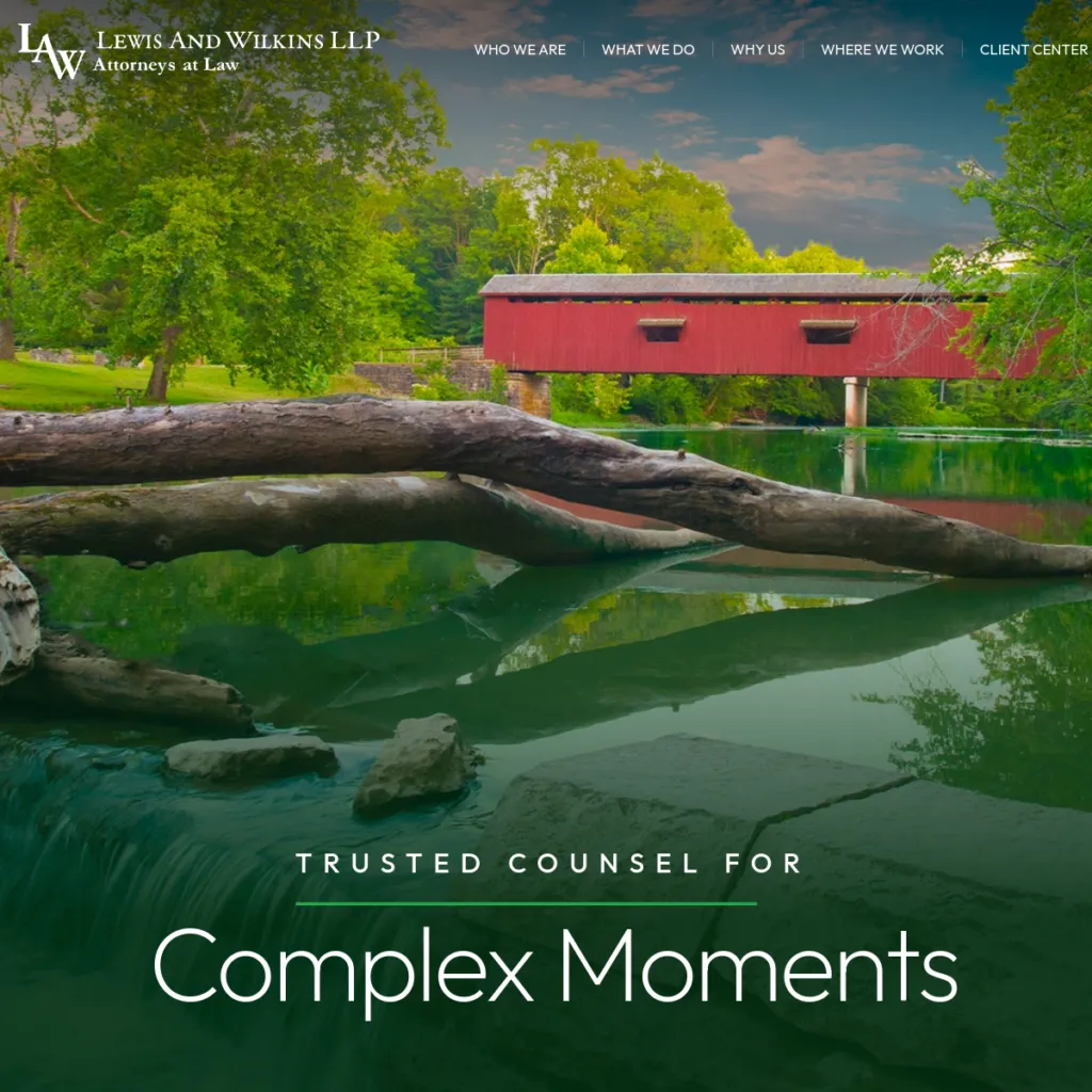 Red covered bridge over a calm river surrounded by green trees, with law firm text overlay.