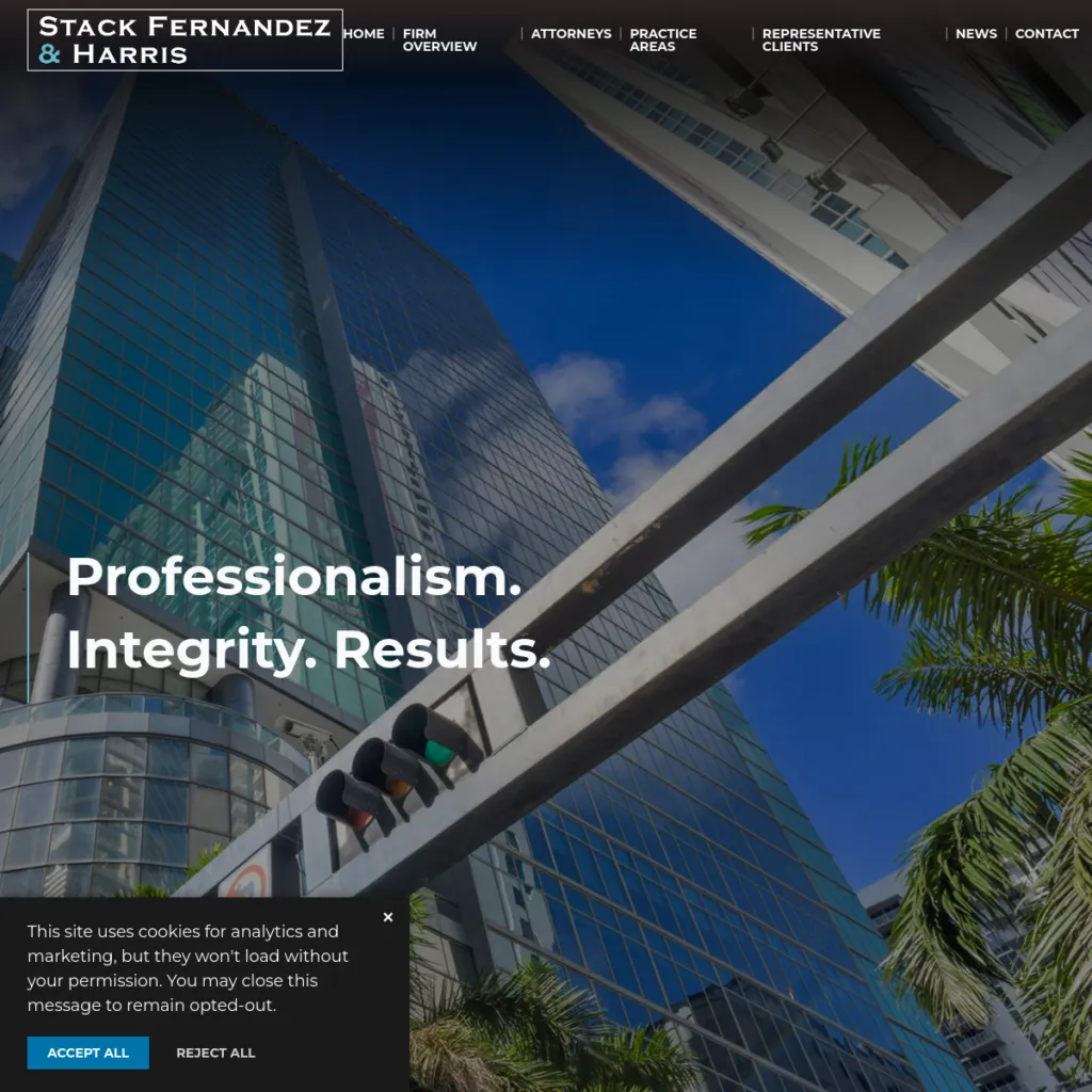 Tall office building with palm trees and a law firm’s name and slogan displayed in the foreground.