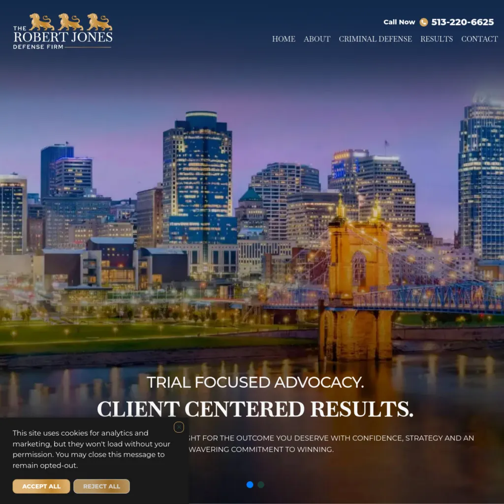 Downtown city skyline at sunset with a lit-up bridge in the foreground; law firm website header.